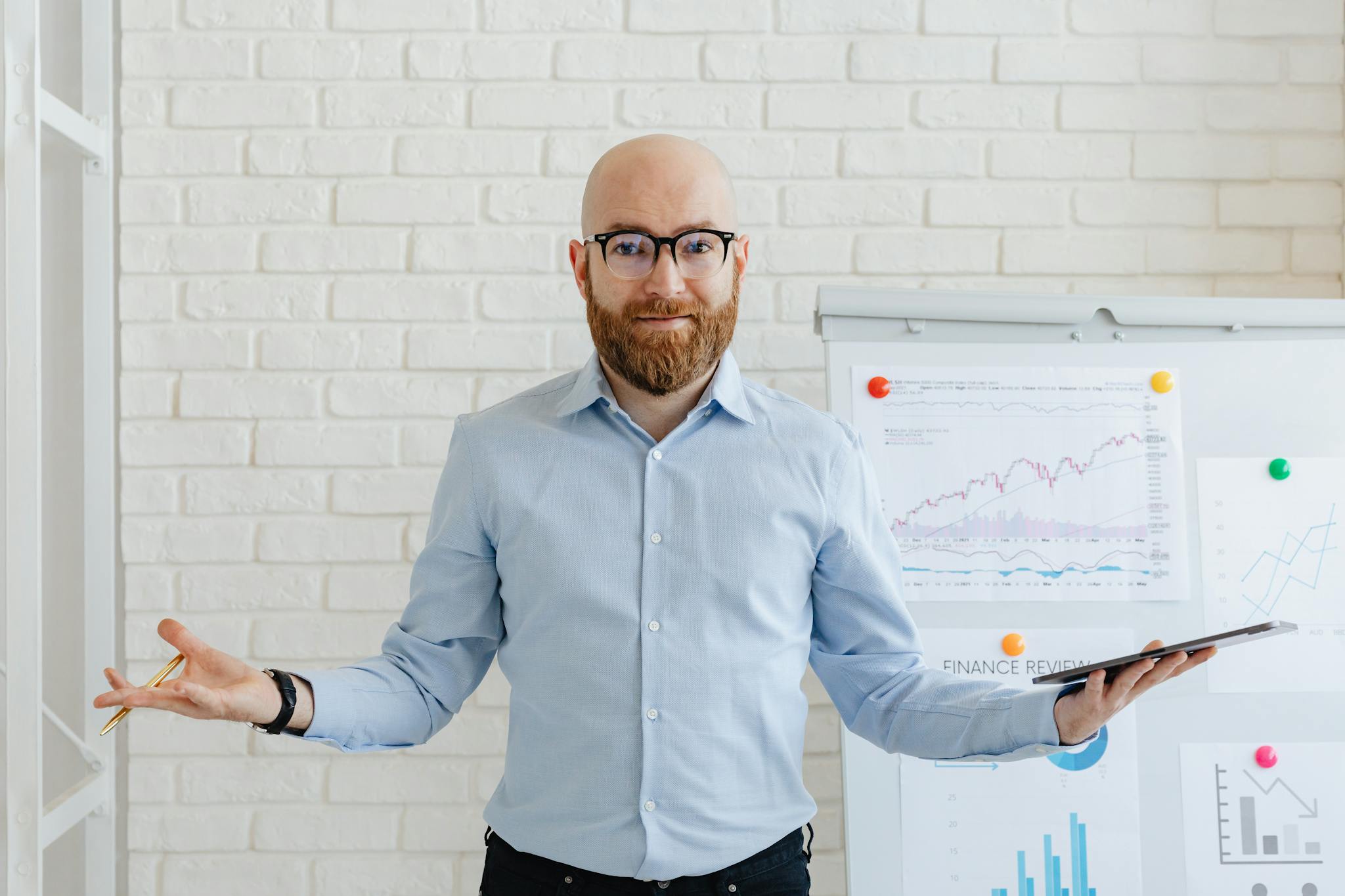 A businessman in an office with charts presenting financial analysis confidently.